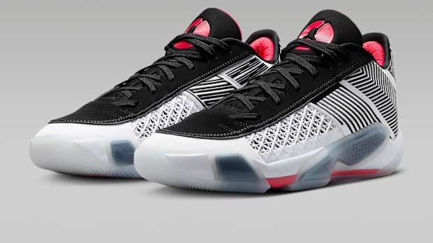 Side view of white, black, and red Air Jordan sneakers.
